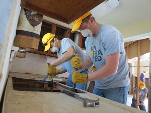 Nick Fontenot, left, and Caleb Stephens of Tennessee Tech work to remove a kitchen countertop from a home in Walker, La.