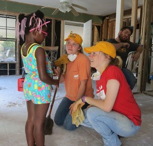 Abby Collier, left, and Courtney Edwards of Tennessee Tech visit with Lulu as their team worked to help clean out her house that had been damaged by flooding.